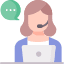 A woman with a headset on sitting at a table.